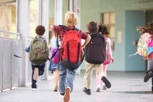 stock image of children in a school hallway for a blog about back to school rashes for children in NYC