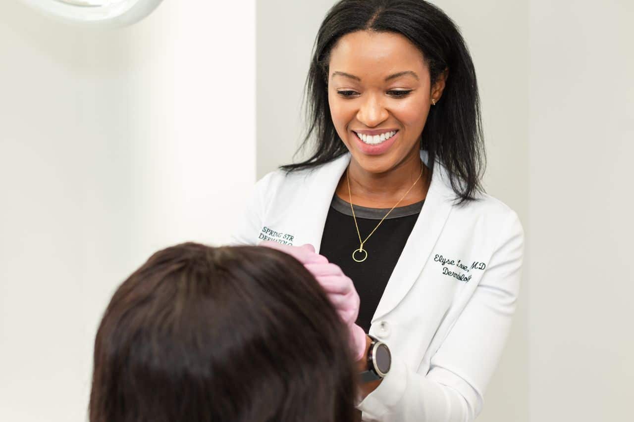 Dr. Elyse Love is using Botox on her patient to treat forehead wrinkles