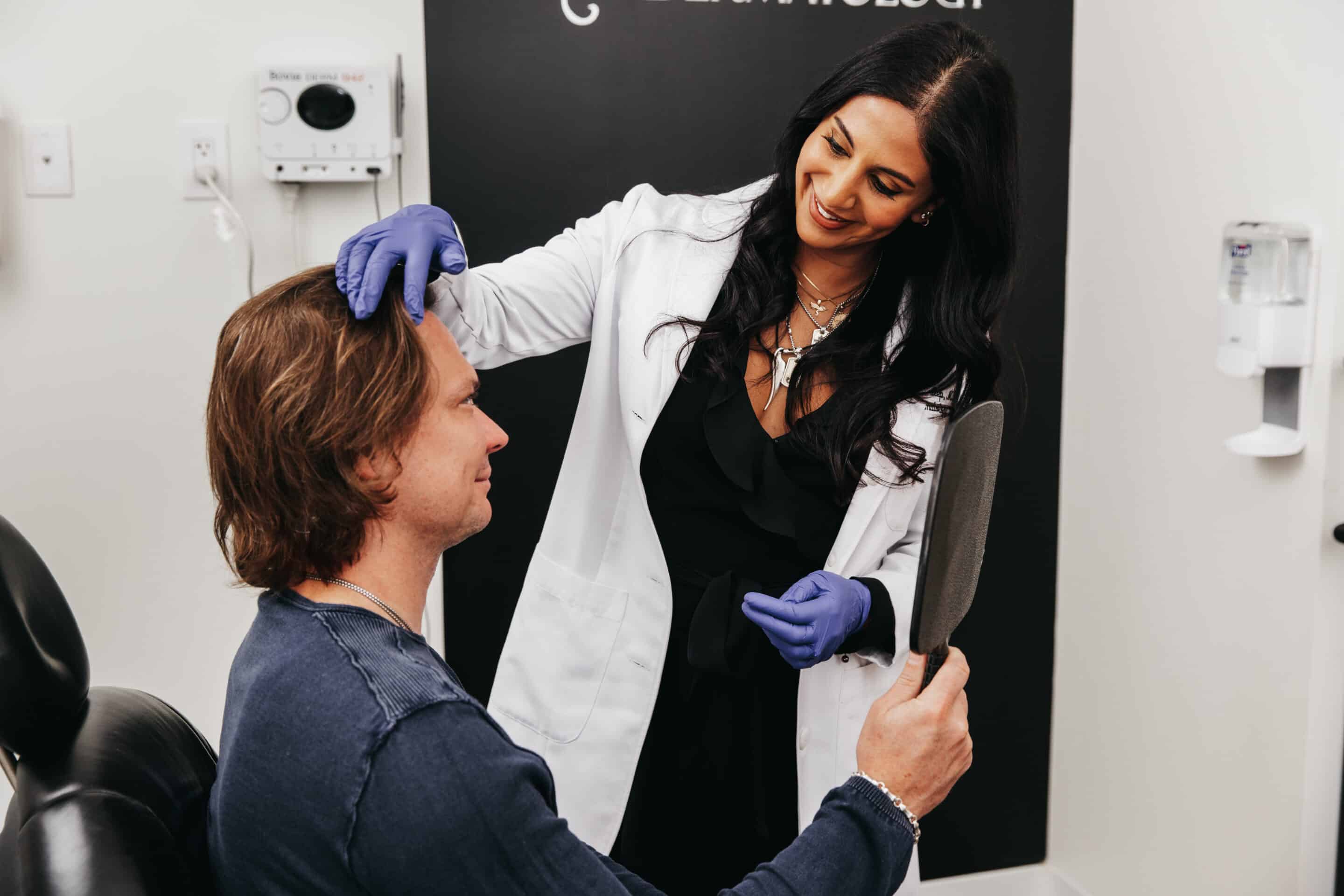 Image showing Dr. Dhingra, board certified dermatologist checking his patient  for cosmetic treatments at Spring Street Dermatology, New York City, NY 